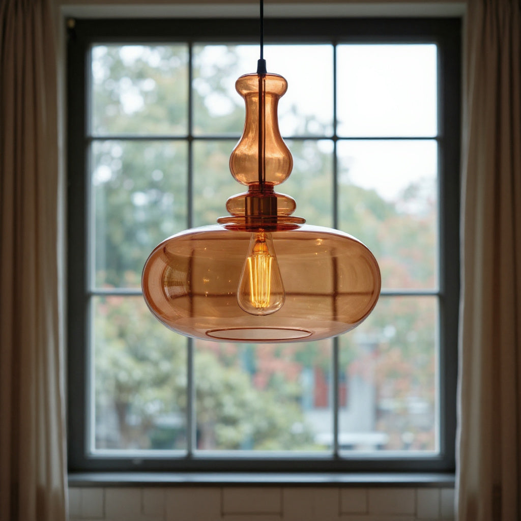 Brown glass pendant light with a visible bulb hanging in front of a window.