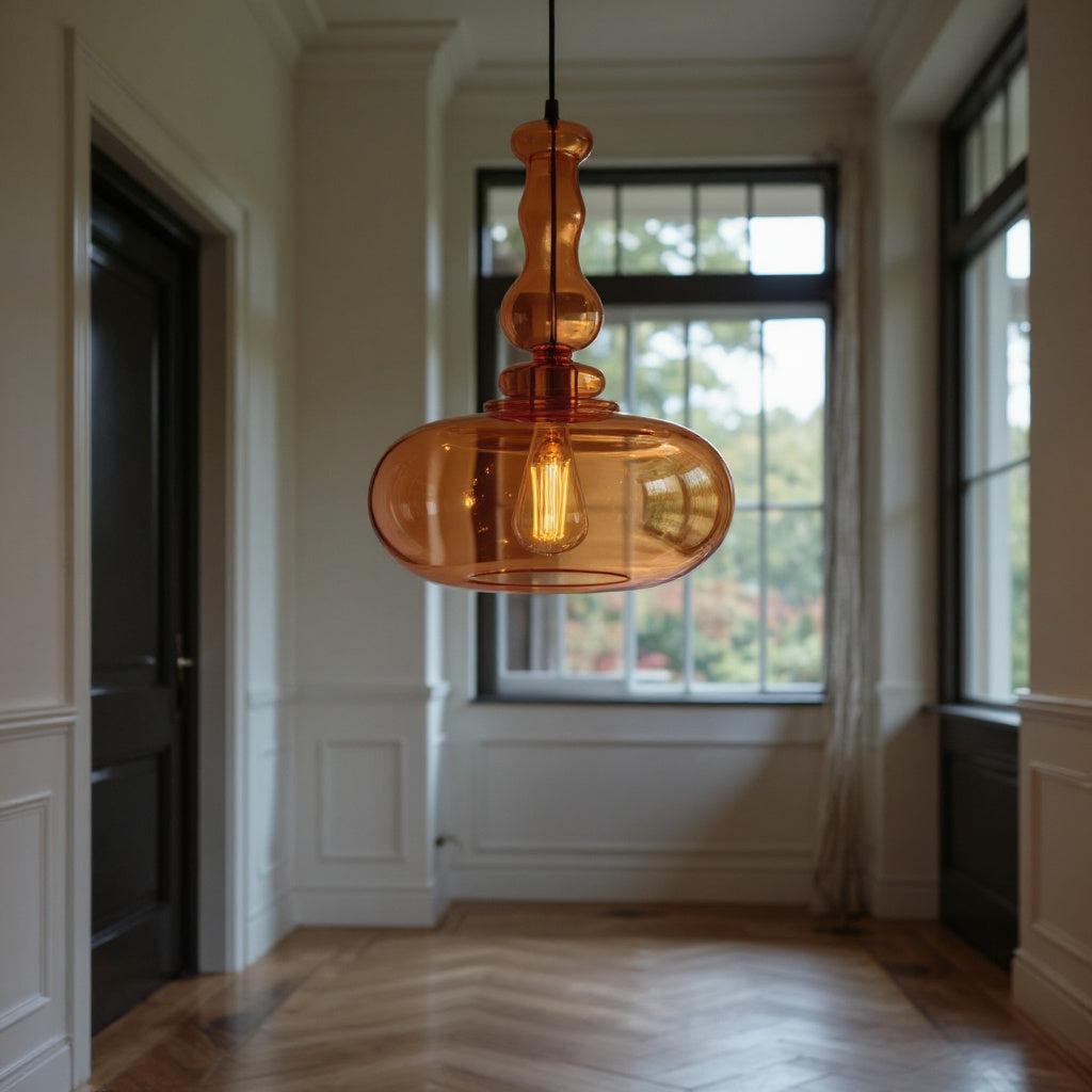 Amber glass pendant light hanging in a room with large windows.
