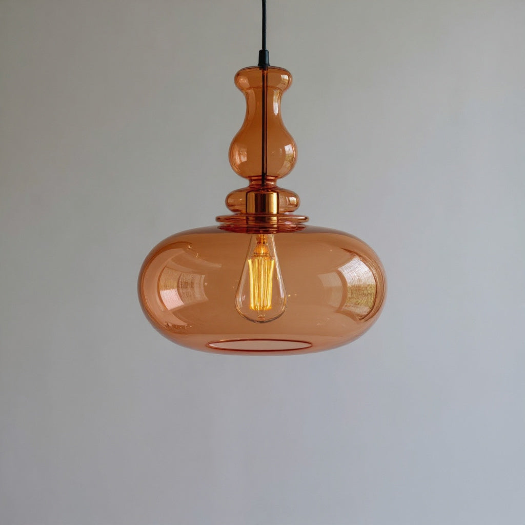 Amber glass pendant light against a plain background